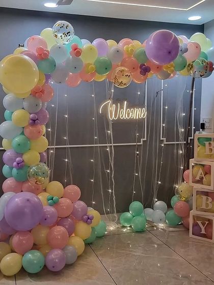 Another angle of the pastel balloon arch and "BABY" blocks, showing the full arrangement.