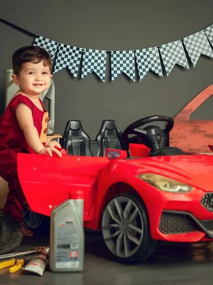For the little car enthusiast. This mechanic-themed cake smash comes complete with a toy car, tools, and a checkered flag for a truly unique first birthday.