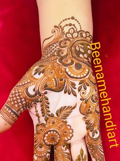 A single hand showing a beautiful Arabic-style design. The flowing patterns and floral motifs are very graceful.