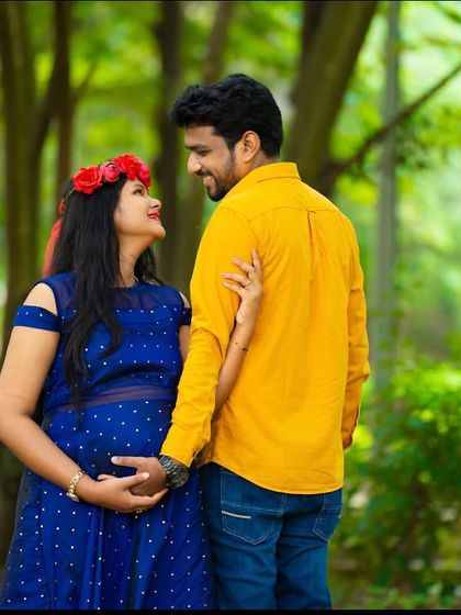 A sweet and candid moment between a couple in a wooded area. The natural setting and their joyful interaction make for a warm and authentic portrait.