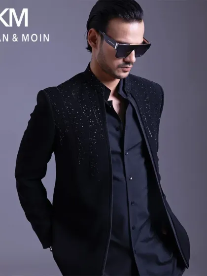 A closer look at the open designer bandhgala, showing the subtle shimmer on the shoulders. Paired with sunglasses, it creates a sharp, confident, and modern ethnic look.