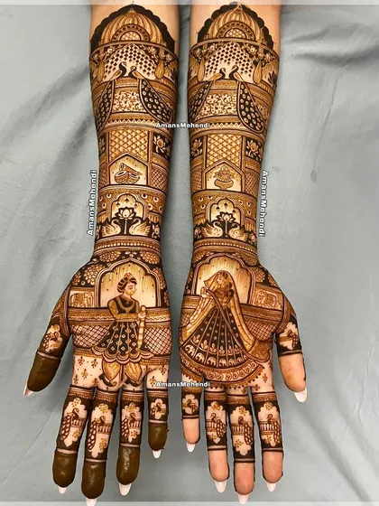 A beautiful bridal design for a special bride. The palms feature portraits of the bride and groom, while the arms are decorated with intricate patterns of peacocks and palaces.