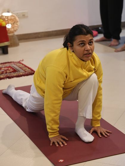 A student practices Ashwa Sanchalanasana, the equestrian pose, during a Surya Namaskar course. This posture is excellent for opening the hips.
