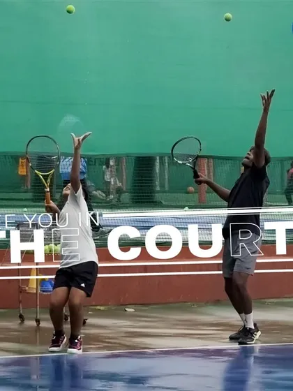 Two players practice their serves in unison, a great example of the focused training environment at our facility. Repetition and practice are key to mastering the game.