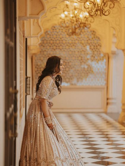 A candid shot of the bride laughing joyfully in a palace hallway, capturing a moment of pure happiness.