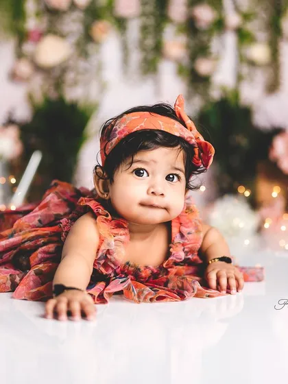 Tummy time fun! Even if your baby is still mastering sitting, we can capture beautiful moments during tummy time, like this little one in her floral dress.