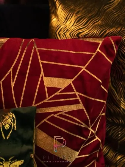 We used bold, patterned cushions to add a pop of color and texture to the lounge seating. The mix of red, gold, and green velvet with insect and geometric prints added to the quirky, magical feel.