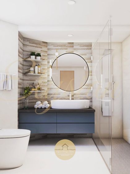 Another bathroom design, this one with a blue vanity and a round mirror. The space is bright and clean, with wood-look tiles on the accent wall adding warmth and texture.