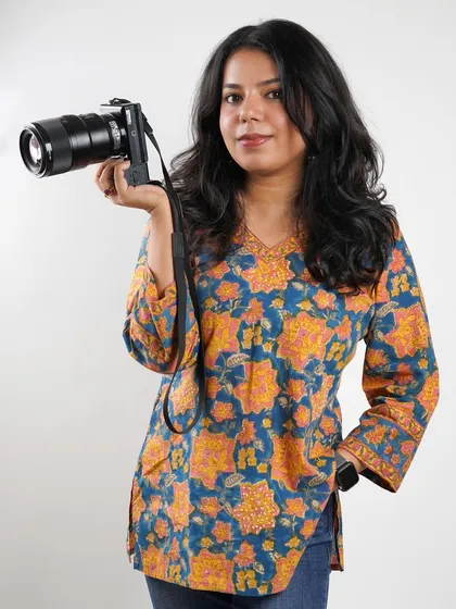 A portrait of me with my camera. I believe my ADHD is my creative superpower, keeping me energized and innovative on every shoot.