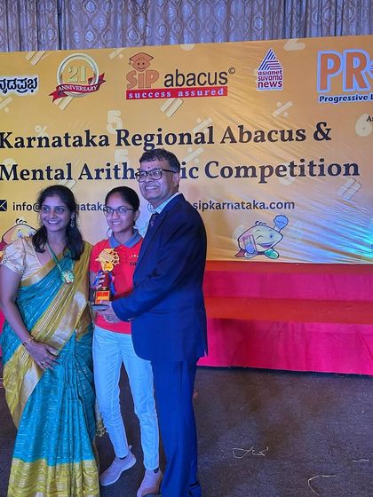 Another proud family celebrating their daughter's achievement at the state-level competition. We are a community of students, teachers, and parents.