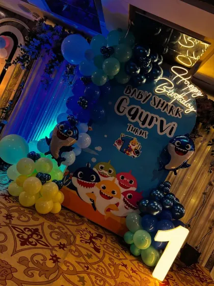 An angled shot of the Baby Shark setup, highlighting the neon sign and the light-up number one.