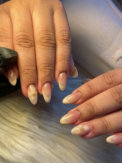 A closer look at the smooth finish and delicate details of this subtle summer manicure. The soft ombre and tiny gold accent create a look that's effortlessly chic.