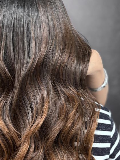A close-up on the soft glam balayage, highlighting the smooth transition of colors and the healthy texture.