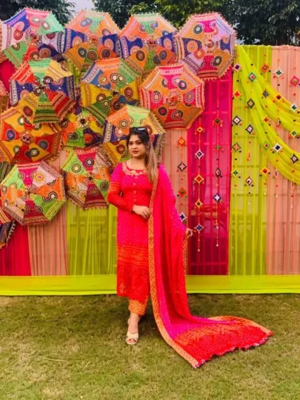 Photo backdrops are essential, and I enjoy creating fun, memorable spots like this one. The wall of colorful Rajasthani umbrellas and bright fabric drapes provides a perfect, Instagram-worthy setting for guests.
