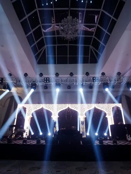 Setting the stage for an epic party. This shot of the sangeet stage with dramatic lighting shows my eye for capturing the ambiance and scale of your event.