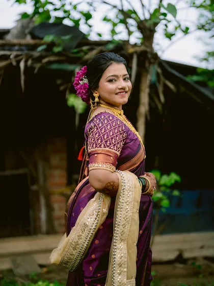 A portrait of the bride, Aarti, showcasing her beautiful smile and traditional Maharashtrian look.