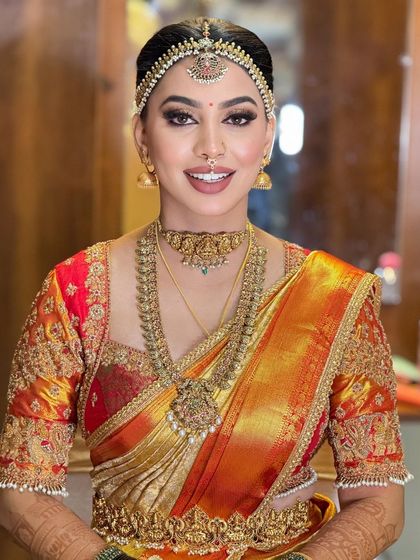 A classic portrait of the bride, showcasing her beautiful smile and the flawless application of her makeup.