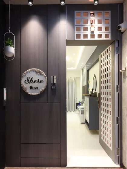 The entrance to this Santacruz home opens to reveal a glimpse of the bright, contemporary living area inside. This view establishes a consistent design language from the moment you step through the custom-designed safety door.