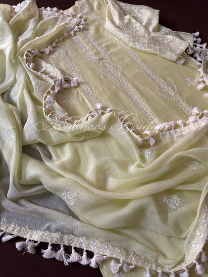 This image captures the movement of the soft dupatta and its delicate tassel details.