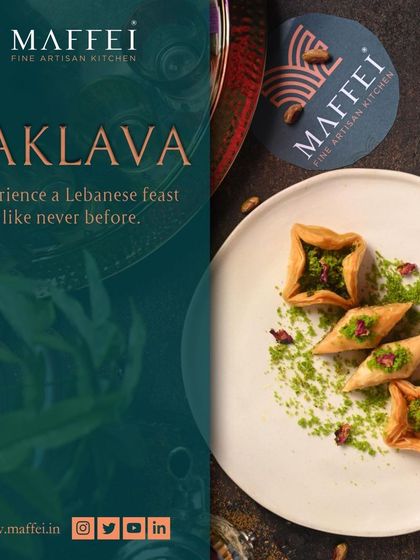 A plate of our beautifully crafted baklava, presented in different shapes and dusted with pistachio. Each piece is a small work of art.