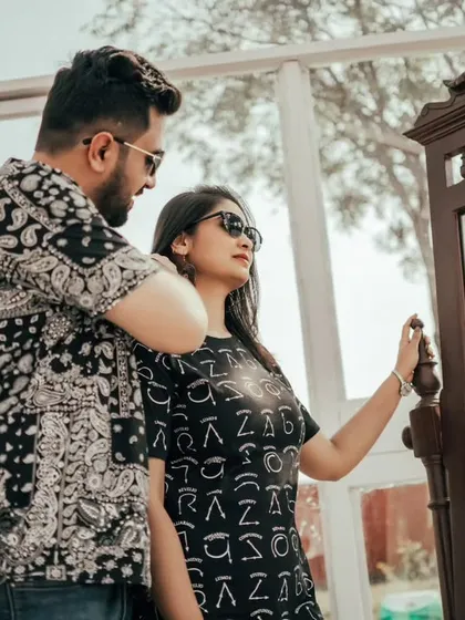 A couple poses in front of a mirror inside one of our modern indoor sets. This setup allows for creative reflection shots and adds a layer of intimacy to your pre-wedding photography.