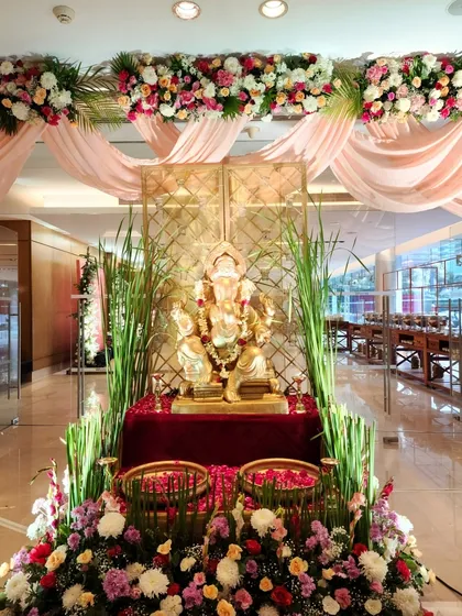 A closer look at the Ganesha entrance decor. The idol is placed on a red velvet pedestal and surrounded by fresh flowers, creating a vibrant and blessed start to the festivities.