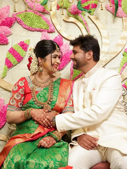 A candid moment from a couple's photoshoot. Their genuine smiles and traditional attire make for a heartwarming and authentic portrait, perfect for celebrating special occasions.