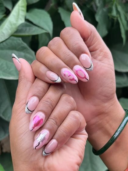 A different angle of the special 30th birthday nails, showing off the mix of pink chrome, silver glitter, and black linework.