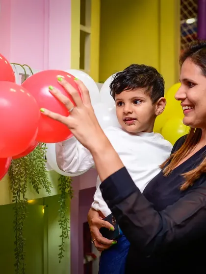 The joy of little things. A mother and child sharing a sweet moment with some balloons.