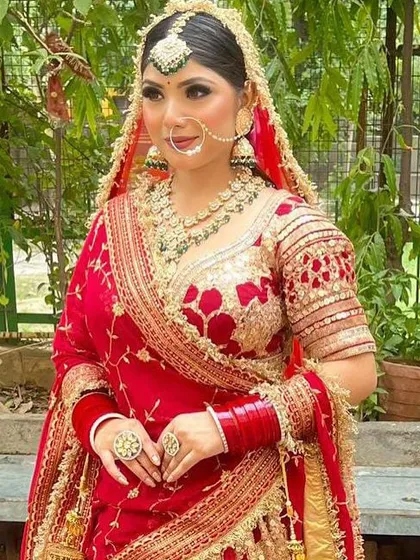A close-up of my classic HD bridal makeup. I focus on creating a flawless, radiant base that looks stunning in photos and lasts all day. Notice the defined eyes and perfectly blended skin, creating a timeless look for this beautiful bride in her red lehenga.