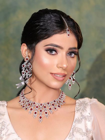 A clean and elegant look for a reception or cocktail party. The focus is on the beautiful diamond and ruby jewelry, paired with a simple, chic makeup look.