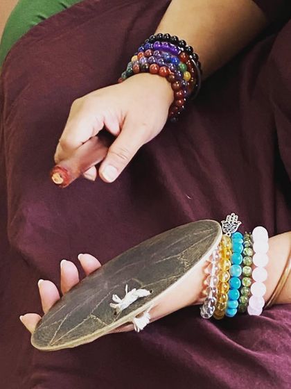 The 'thalam' (cymbals) and a dancer's hand. This image symbolizes the dedication and practice that goes into mastering the rhythm of Mohiniyattam.
