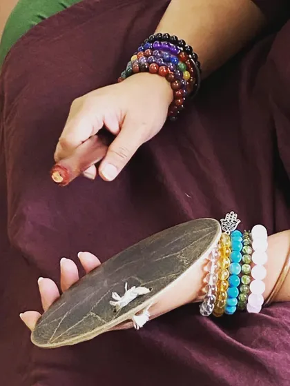 The 'thalam' (cymbals) and a dancer's hand. This image symbolizes the dedication and practice that goes into mastering the rhythm of Mohiniyattam.