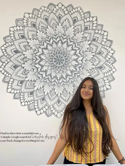 Me with a large custom wall mandala. It all started with a simple Google search for "circular designs," and now it has become my life's passion.