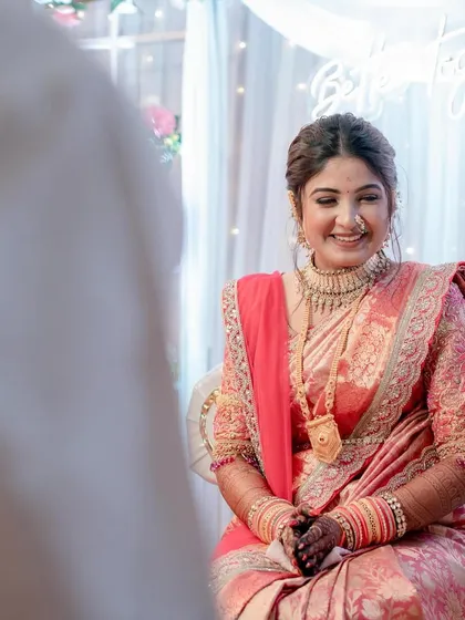 A candid moment of love and laughter at an engagement. The bride's makeup is soft and romantic, perfect for these intimate shots.