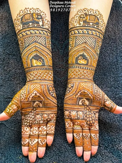 A classic and symmetrical full-hand design. This pattern features elephants and swans within architectural frames, complemented by delicate peacock and floral work.