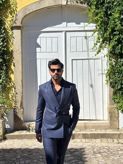 Our navy linen double-breasted suit, captured in a sun-drenched, picturesque setting.