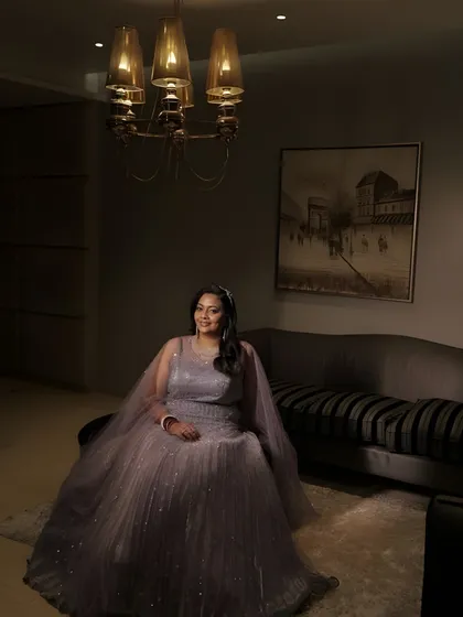 A posed shot in a modern interior. The bride's soft glam makeup and elegant gown create a look of timeless sophistication.