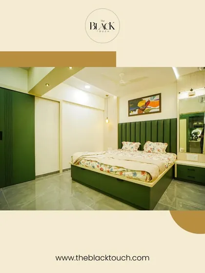 A bedroom designed with a refreshing green theme. The upholstered green bed and matching wardrobe create a cohesive and calming environment, perfect for a nature-inspired retreat.