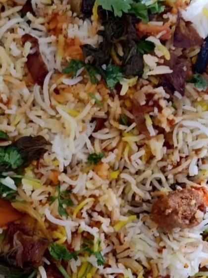 A closer look at the Chicken Kebab Biryani, showing the texture of the rice and the well-cooked meat. It is a hearty and flavorful one-pot meal.