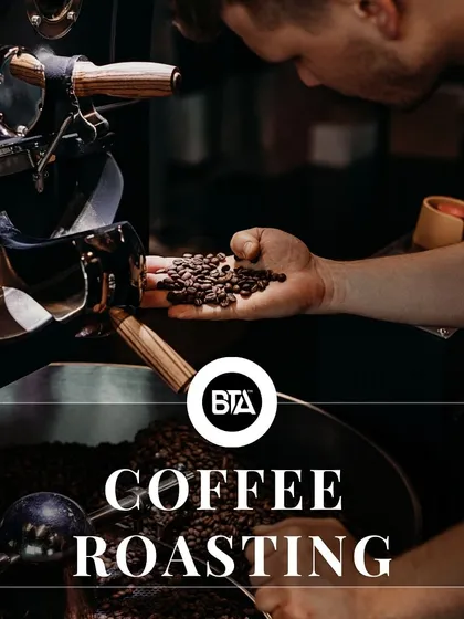 A close-up of a coffee roaster, representing the crucial roasting stage in the coffee's journey.
