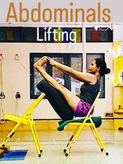Here, the action is focused on lifting the abdominals. The chair provides a stable base, enabling the student to focus on the upward lift from the lower belly, a key action for inversions and backbends.