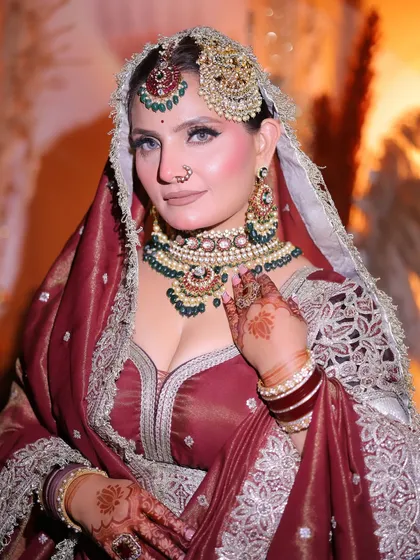 A closer look at the details. The makeup features a neutral lip to balance the heavy jewelry and a sharp winged liner to accentuate the eyes.