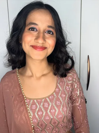 A simple yet elegant look for a party. I gave this client a fresh, rosy makeup look with soft curls to complement her dusty rose lehenga.