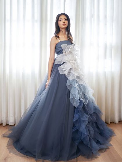 This is 'Ocean', a dreamy tube gown with a detachable floral skirt. You can wear it as a simple, elegant gown or add the ruffled skirt for extra volume and drama.