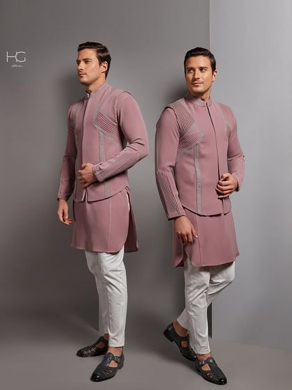 Redefining tradition with grace. This dusty rose Indo-Western set features a layered, structured jacket over a matching kurta, creating a soft yet strong silhouette.