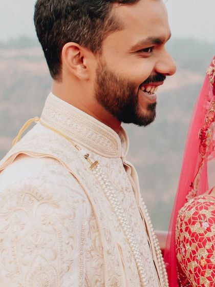 A candid shot of the groom, smiling and happy on his wedding day. We believe in capturing the groom's moments just as much as the bride's.