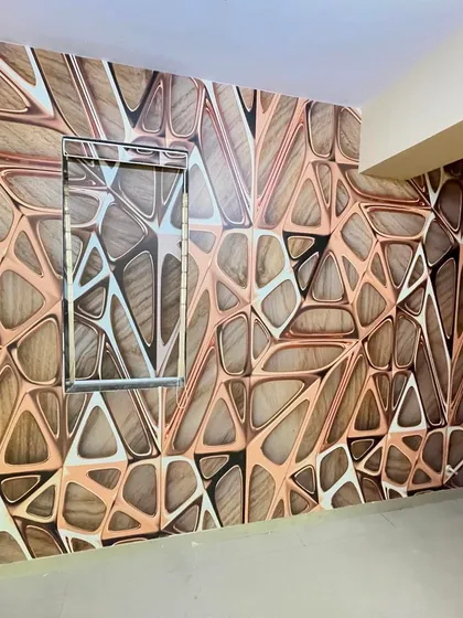This room features a unique 3D wallpaper with an abstract, geometric pattern in wood and copper tones, creating a warm and modern accent wall.
