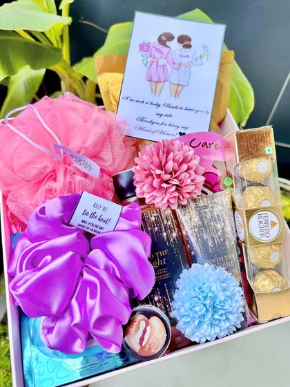 A super lush hamper curated specially for the Maid of Honor. It's packed with a full-size shower gel, a giant scrunchie, Ferrero Rocher, a Body Shop lip balm, and a custom illustrated card.