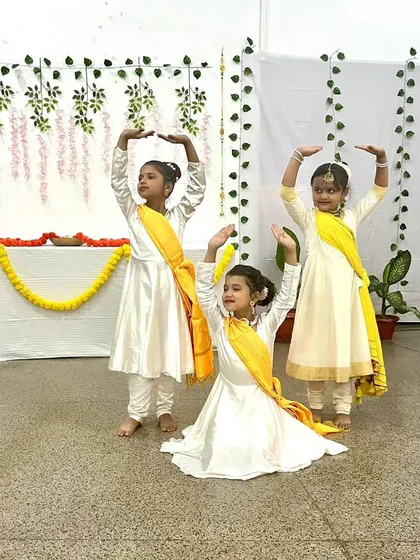 Our youngest budding stars preparing for their Kathak performance. We create a nurturing environment for children to develop balance, rhythm, and a love for our cultural heritage from an early age.